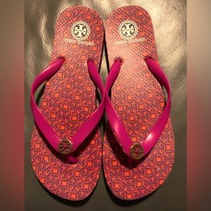 Tory Burch logo print flips in fuchsia/orange. No size shown-total length is 11”